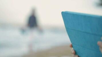 Boy and mother using pad on the beach video