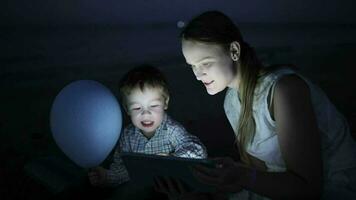 Kid with mom on the beach at night video