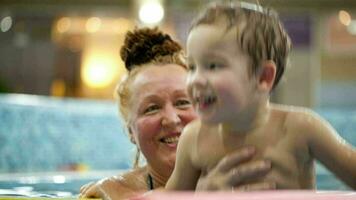 Grandmother and a grandson in the swimming pool video