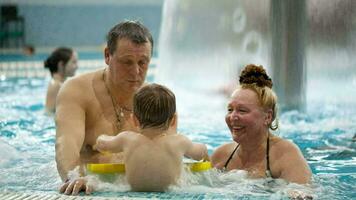 Grandparents and a grandson in the swimming pool video