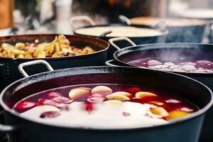 Beverages fruits and berries hot mulled wine in pots with steam in street food market. Generative AI photo