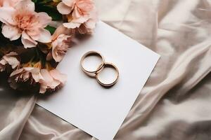 Top view wedding rings and paper with flowers photo