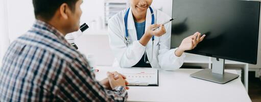 Doctor consulting with patient discussing something and Presenting results on report, Medicine and health care concept. photo