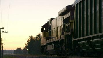 Freight train passing by in the countryside video