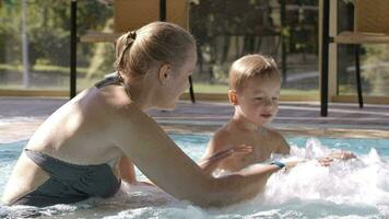 Mother and her son in the swimming pool video