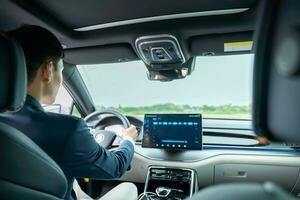 A man driving inside of electric car. Electric car. EV Car. EV vehicle. photo