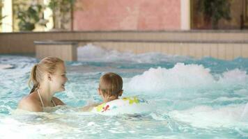 Mother and her son in the swimming pool video