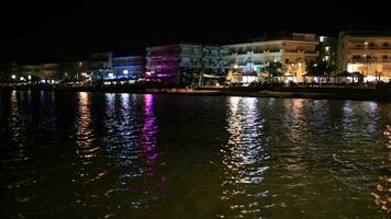 Illuminated waterfront buildings at night video