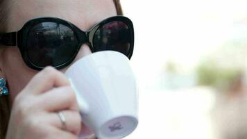 Young woman drinking coffee video