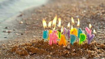 Birthday candles burning on a seashore video