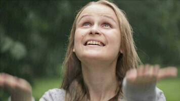 Girl enjoying rain in the park video