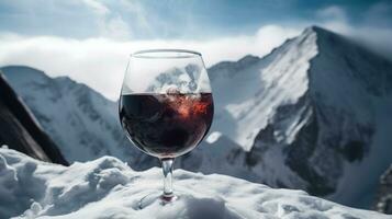 Glass of hot red wine close-up, background of snow-capped ski peaks of mountains. AI generated. photo