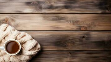 A rustic wooden table adorned with vintage knitted sweaters and cozy mugs background with empty space for text photo