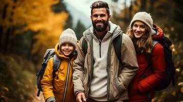 A happy family enjoys a hike through colorful autumn leaves background with empty space for text photo