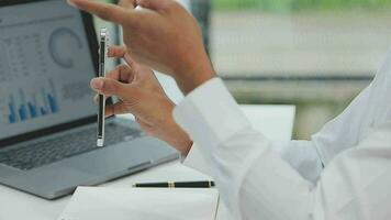 Financial analysts analyze business financial reports on a digital tablet planning investment project during a discussion at a meeting of corporate showing the results of their successful teamwork. video