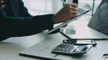 Close up businessman hand using calculator and working with laptop calculate about finance accounting at coffeeshop outdor.finance accounting concept video