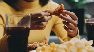 people are eating food, fried chicken together. video