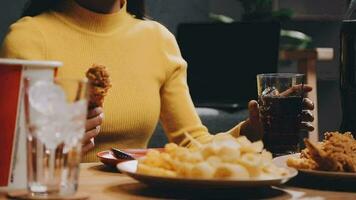 people are eating food, fried chicken together. video