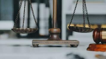 Business and lawyers discussing contract papers with brass scale on desk in office. Law, legal services, advice, justice and law concept picture with film grain effect video