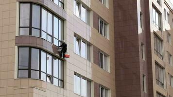 Man washes the windows of office building 1 video