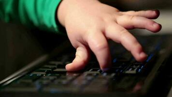 Two year old boy is playing with computer video