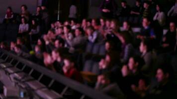 Defocused people applaud at theatre video