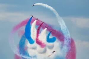 Aerobatic team at airshow. Flight demonstration and formation flying. Air force and military show. Airport and air base. Aviation and aircraft. Fly and flying. photo