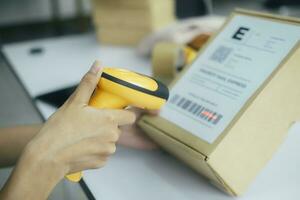 Scanning parcel barcode before shipment. photo