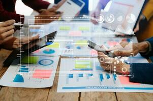 Businessman hand Project manager working and update tasks and Gantt chart scheduling virtual diagram.with smart phone, tablet and laptop in modern office. photo