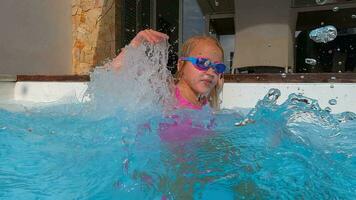 Girl playfully splashing pool water video