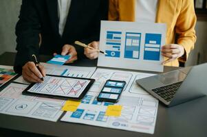 UX graphic designer planning application process development prototype wireframe for web smart phone. Creative digital development agency. photo