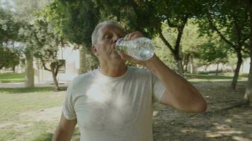 Happy sportsman drinking mineral water video