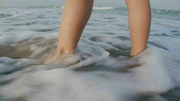 Girl's feet in the ocean waves video