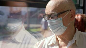 Senior man wearing mask to prevent COVID-19 infection during bus ride video