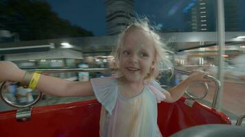 Happy girl in merry-go-round in the evening video