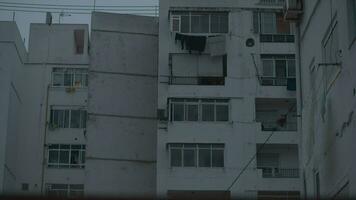 Apartment block with shutters on windows, evening view video