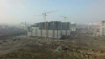 Residential complex with high-rise apartment houses under construction, aerial video