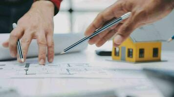 Construction and structure concept of engineer working drawing on blueprint meeting for project working with partner on model building and engineering tools in working site, construction concept. video