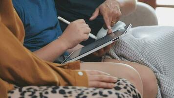 smiling father and daughter taking selfie on smartphone while mother and son using laptop together at home video