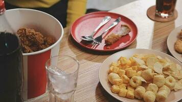 Closeup image of a beautiful asian woman enjoy eating french fries and fried chicken in restaurant video