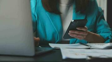 Portrait of a happy Asian businesswoman using mobile phone indoor, Asian businesswoman working in modern office. video