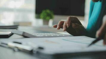 Close up Businesswoman using calculator and laptop for do math finance on wooden desk in office and business working background, tax, accounting, statistics and analytic research concept video