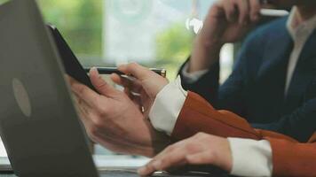 Entrepreneur Asian businessman and businesswoman discussing new business project in tablet in modern Meeting In Modern Office, Asian business casual concept. video