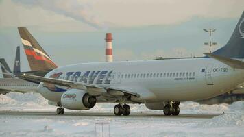 Aircraft of Travel Service taxiing on tarmac at Moscow airport, winter view video
