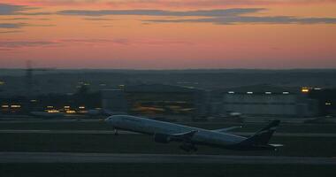 Airplane taking off from runway and flying in the evening sky, Russia video