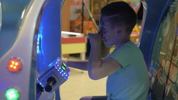 Boy having fun with sea-battle arcade video