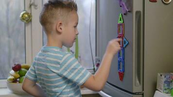 Boy playing with magnetic figures video