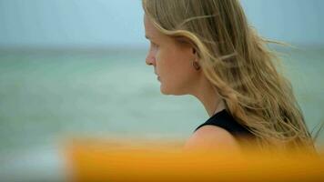 mujer con pelo ondulación en el viento retrato en contra el mar video