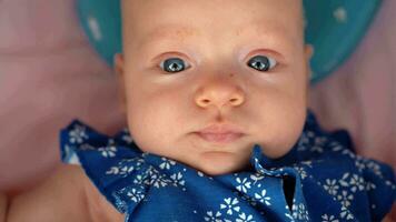 Portrait of baby girl in blue onesie video