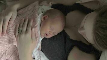 Newborn baby sleeping on mothers chest video